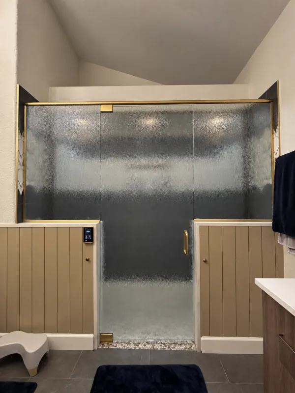 Textured privacy-glass enclosure with brass trim